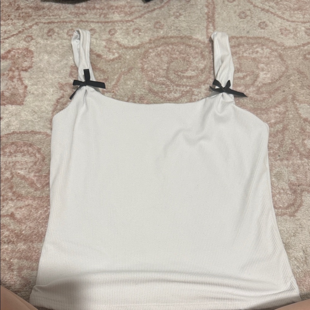White Sleeveless Top with Black Bow Accents